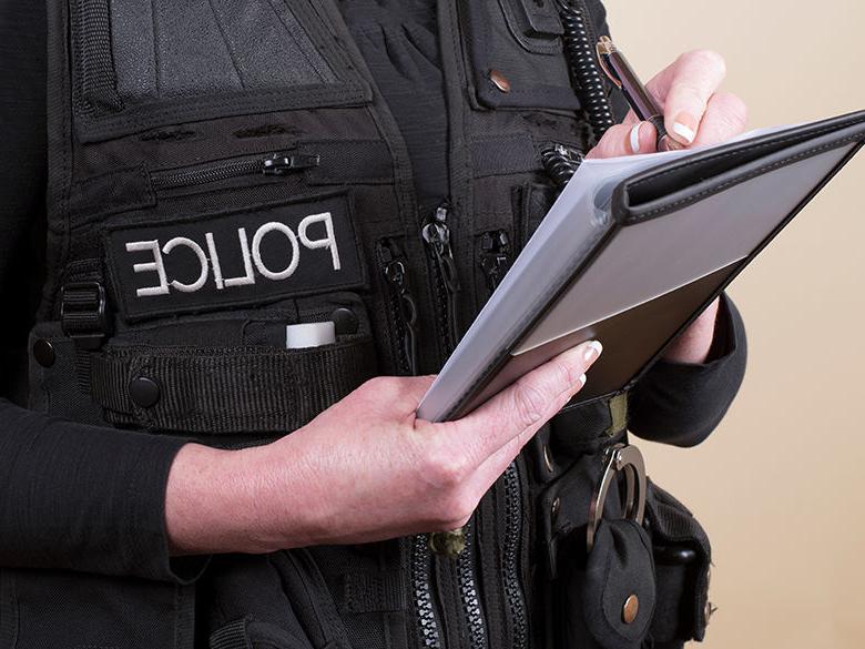 A police officer writing in a notebook